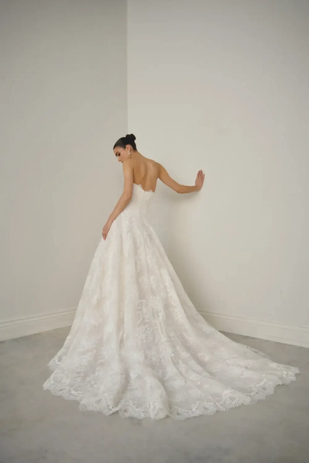model is wearing a strapless ball gown