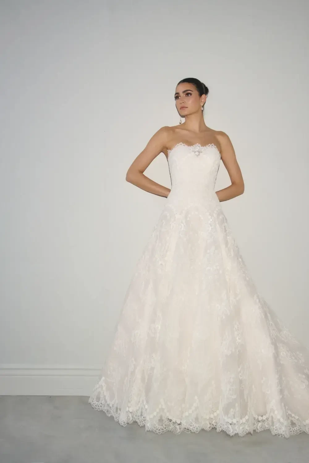 model is wearing a strapless ball gown