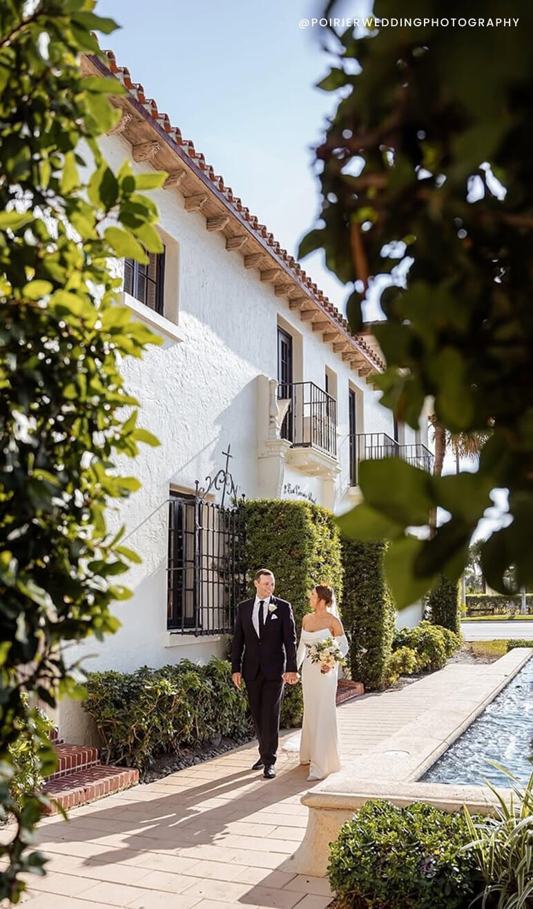 Сouple wearing a white gown and a black suit