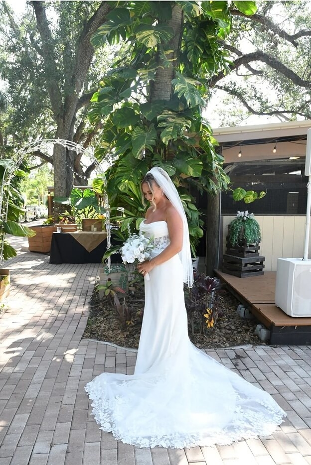 Model wearing a white bridal dress with the flowers