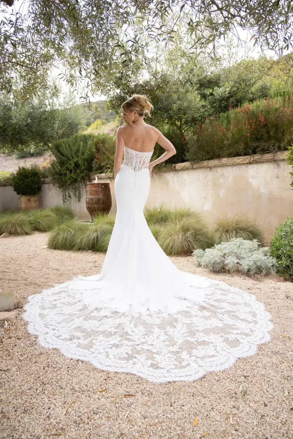 model is wearing a strapless fit and flare bridal gown